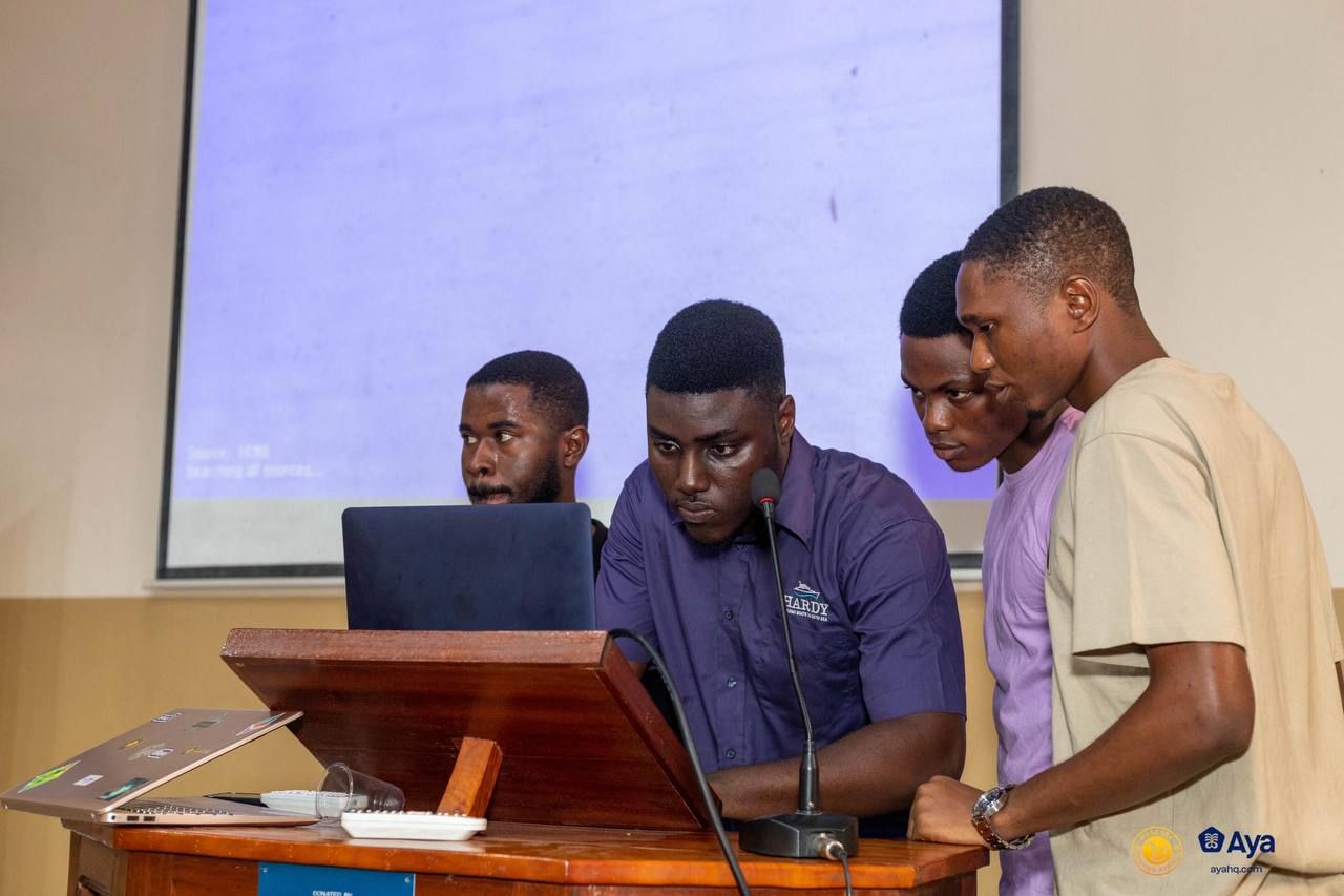 Samuel Dahunsi and teammates at the podium pitching their hackathon project during muAccra