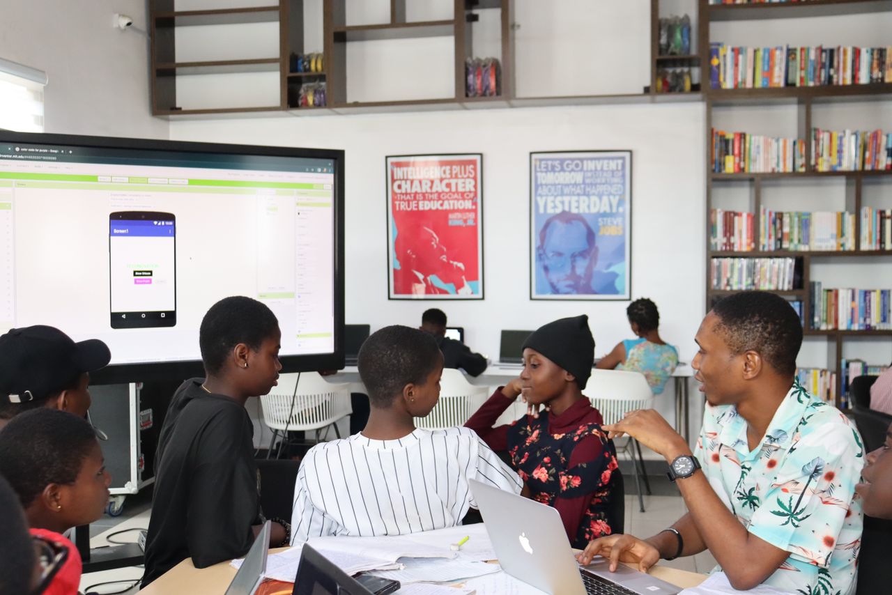 Samuel Dahunsi and fellow mentors guiding Technovation Girls students through an MIT App Inventor project