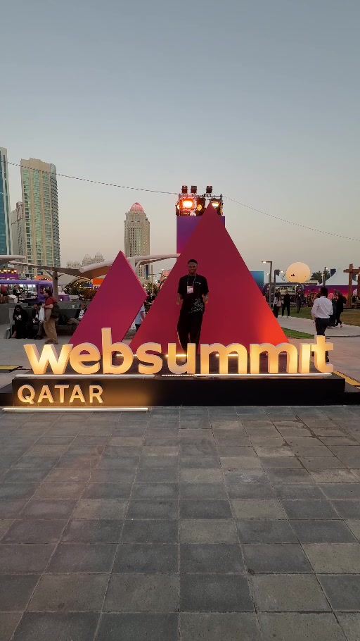 Samuel Dahunsi at the illuminated Web Summit Qatar installation in Doha